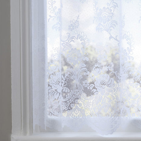 Decorative white floral lace window film on a window