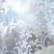 White floral lace net curtains with a soft focus background