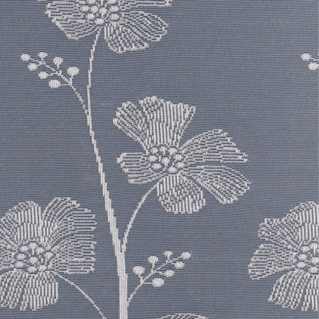 White lace curtain with poppy flower designs against a blue background