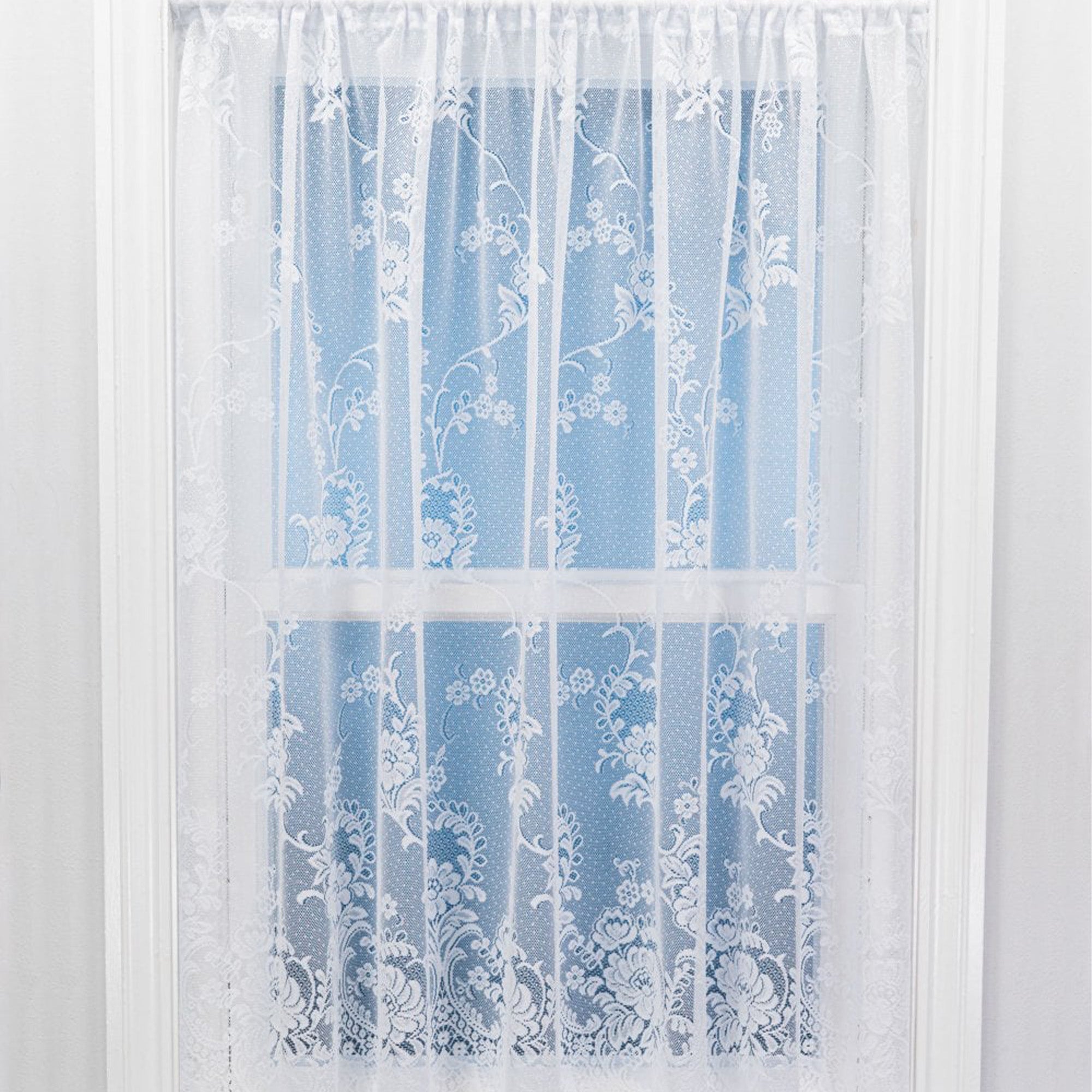 Sheer white floral lace curtain panel on a light blue background