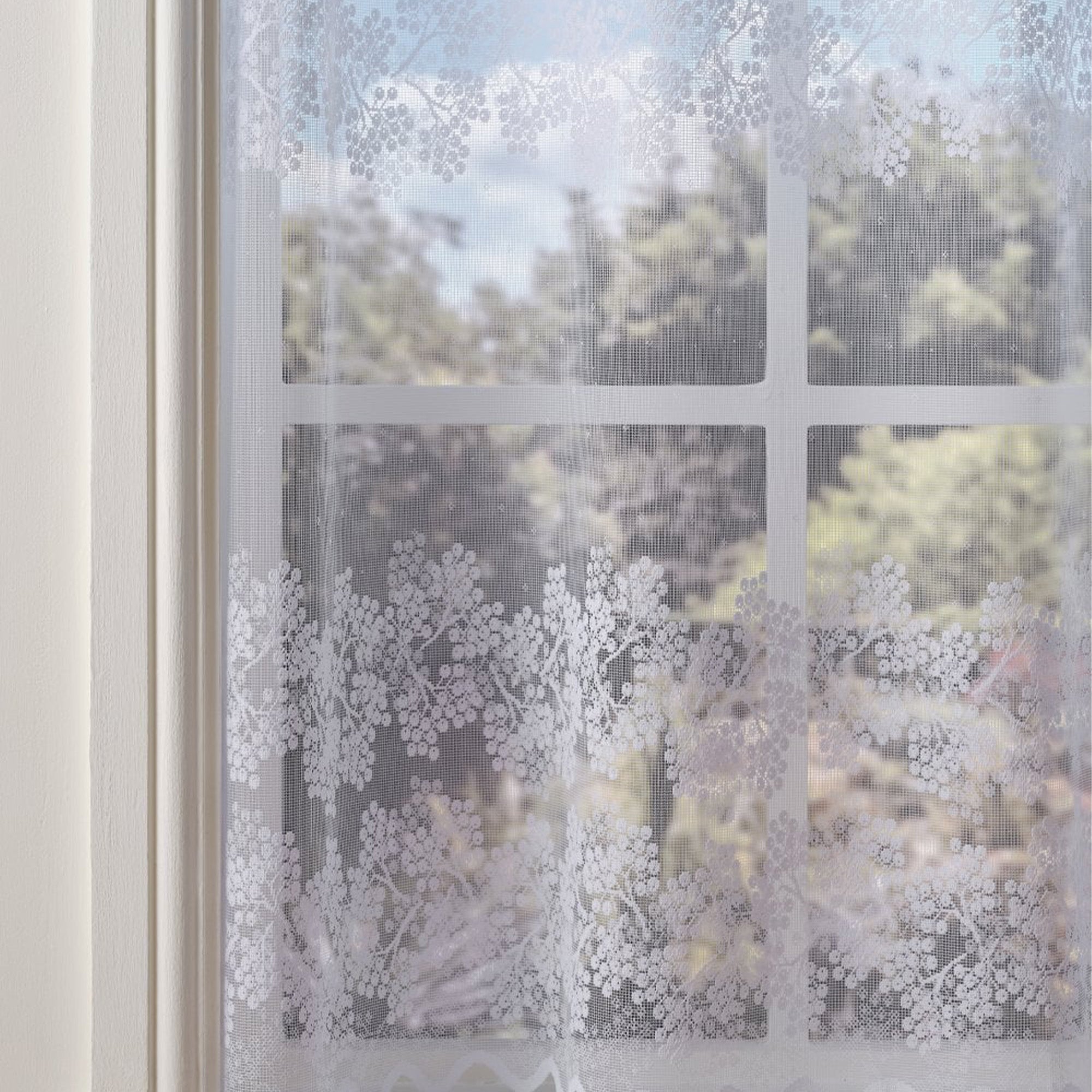 Decorative window film with floral pattern on a glass pane