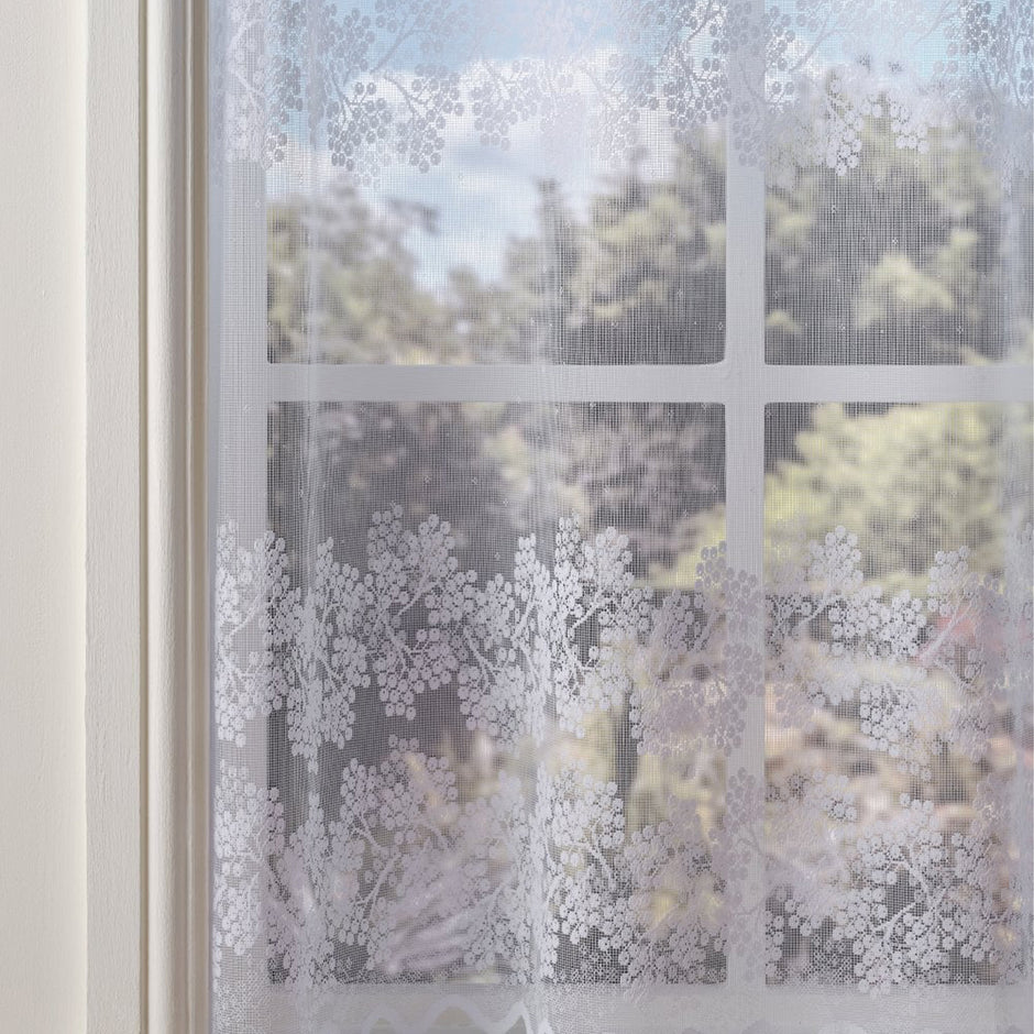 Decorative window film with floral pattern on a glass pane