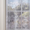 Decorative window film with floral pattern on a glass pane