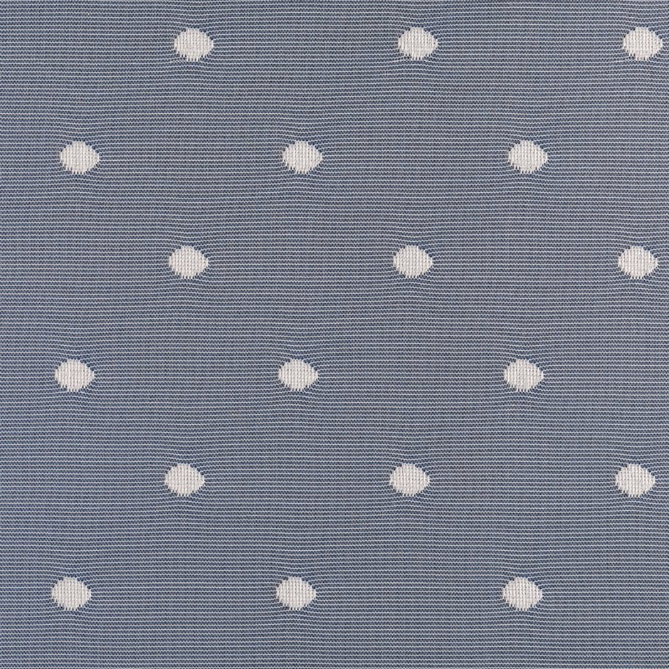 Pattern of white circles on lace curtains against a blue textured background