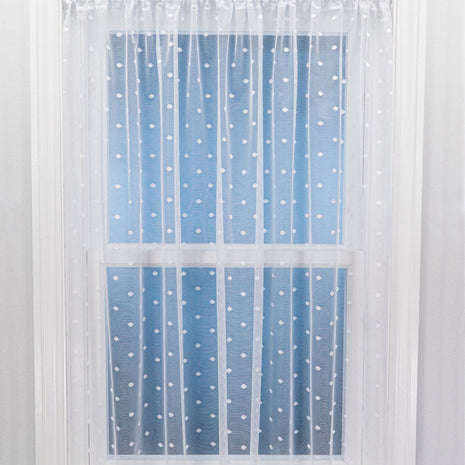 Sheer curtain with white polka dots on a blue background