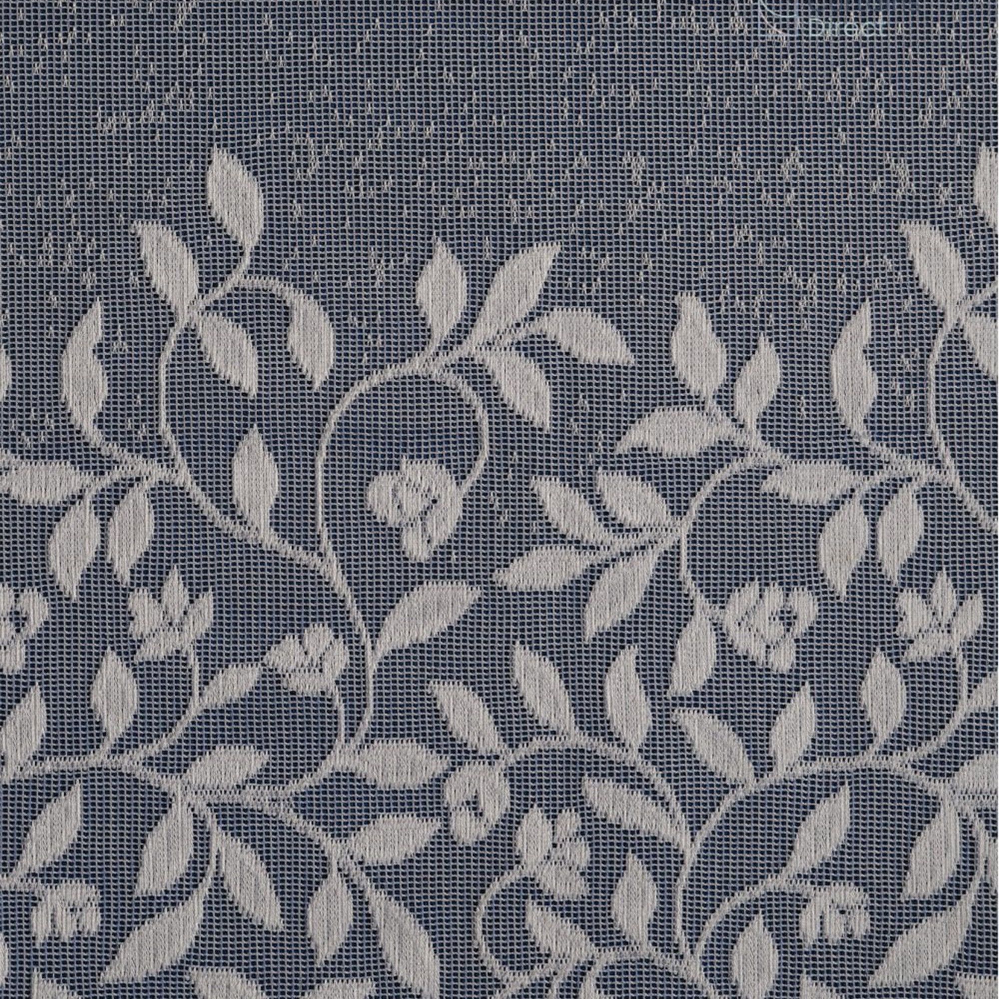 White net curtain fabric with embroidered leaves against a blue background