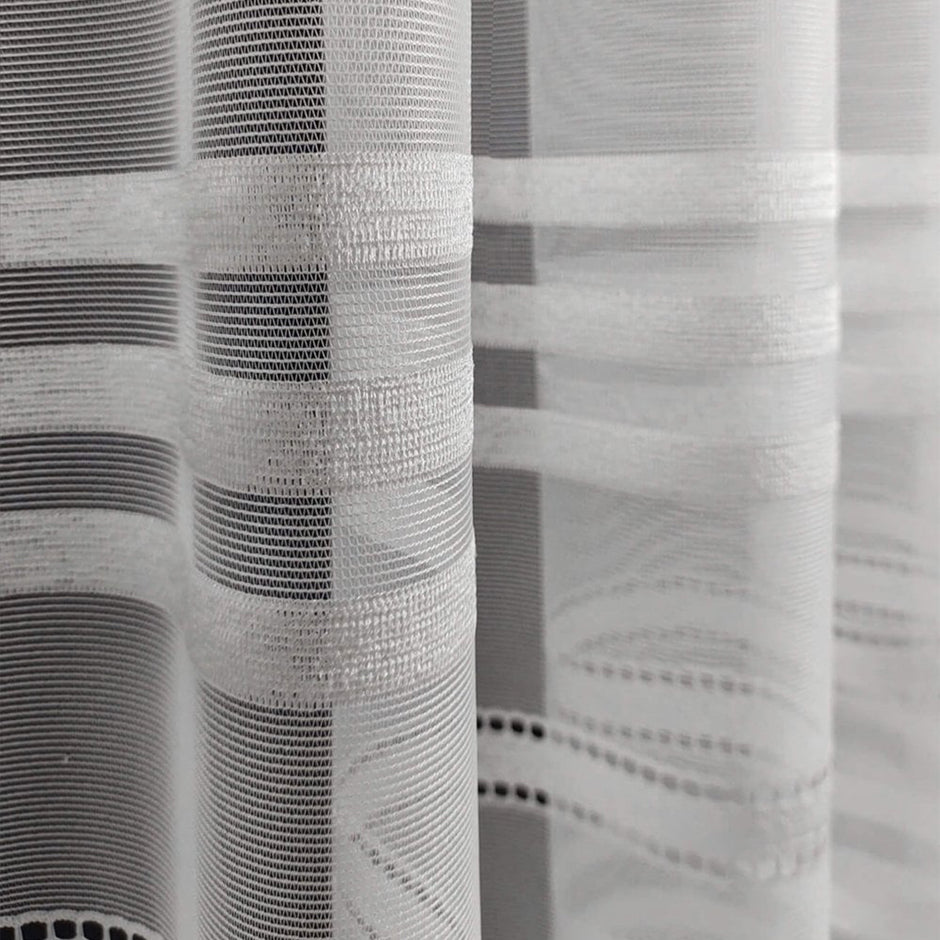 Close-up of a textured white curtain with a stripe pattern