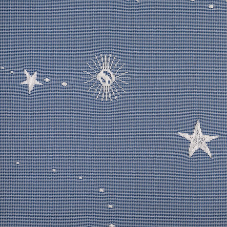 Pattern of stars and moons on lace curtains against a textured blue background