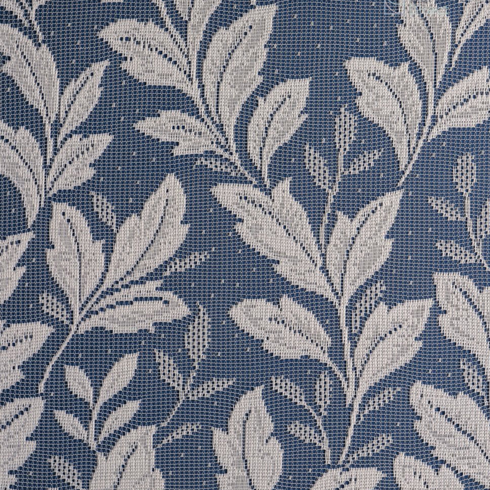 White net curtain with vertical leaf pattern against a blue background