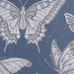 Butterfly pattern on lace curtains against a blue background