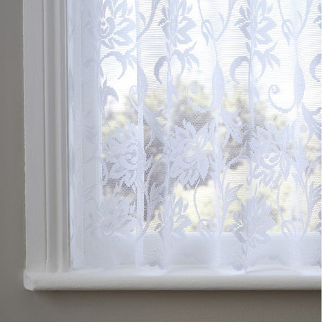 White lace curtain with floral patterns on a window