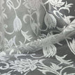 Close-up of floral lace fabric with intricate patterns.
