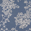 White net curtain with a flower and leaf print against a blue background